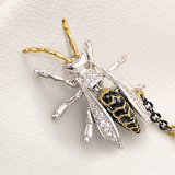 Decorative brooch with chain and beads on a white background