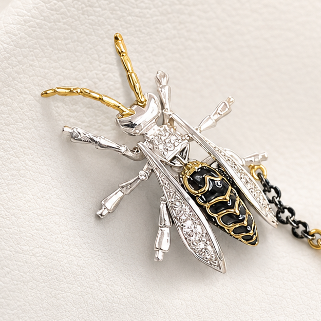 Decorative brooch with chain and beads on a white background
