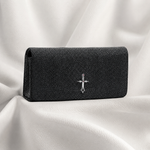 Black textured wallet with a silver emblem on a white fabric background